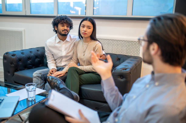 istock Young couple seated in the psychoanalyst office 1394601209