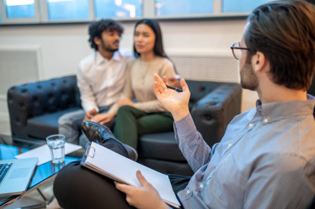 istock Psychotherapist having a conversation with his patients 1394601217