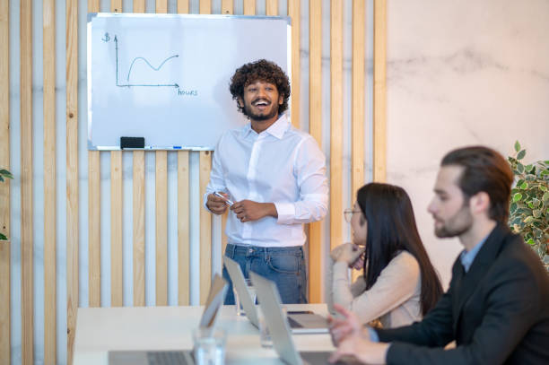 istock Merry company worker speaking in front of his colleagues 1394601253