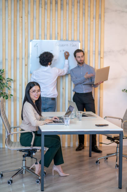 istock Female office worker posing for the camera in the workplace 1394601283