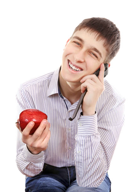 Cheerful Teenager with Apple and Cellphone Isolated on the White Background