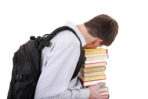 Tired Student with the Books Isolated on the White Background