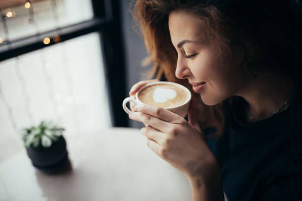 istock Young woman sitting in a cozy coffehouse. 1394603045
