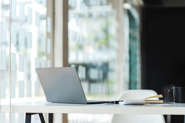 istock Close up of creative designer table with open laptop turned away. Mock up 1394603853