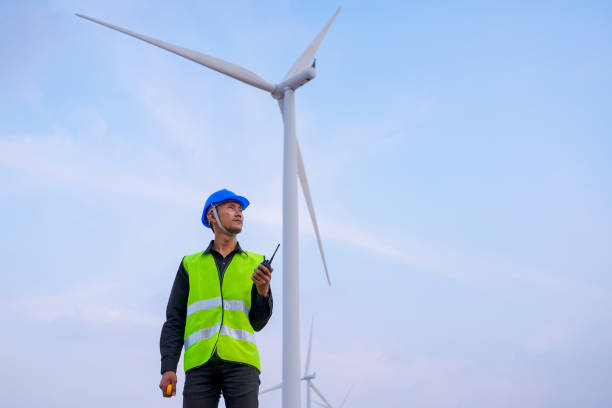 istock Blue collar worker at electricity site. Windmill field. 1394604665