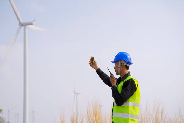 istock Blue collar worker at electricity site. Windmill field. 1394604708