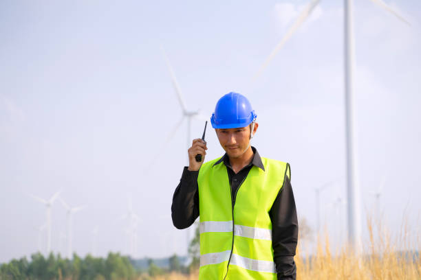 istock Blue collar worker at electricity site. Windmill field. 1394604718