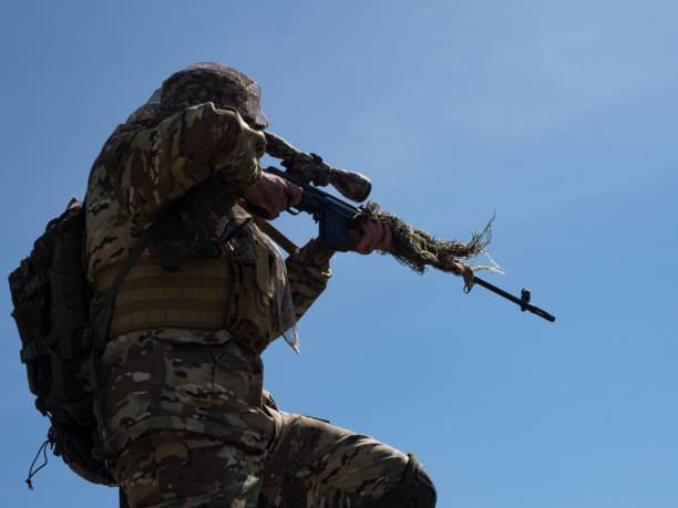 istock A professional special forces sniper during a special operation - aims at the enemy against the blue sky 1394605177