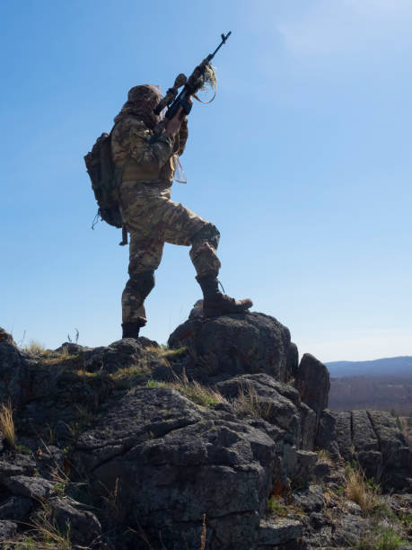 istock Professional special forces sniper during a special operation - he aims at the enemy. Concept of modern military operations and a special operation on enemy territory 1394605193