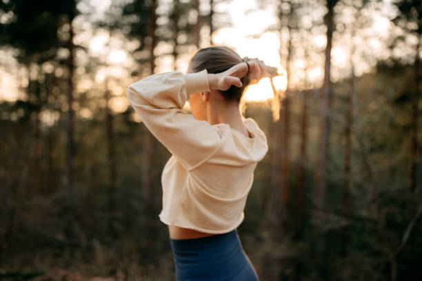 istock Athlete ties her hair in a ponytail before training 1394605716