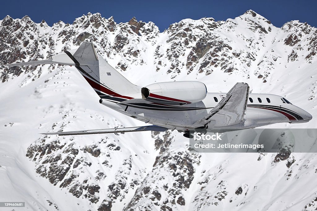 Businessjet Businessjet with snowy mountains Corporate Jet Stock Photo