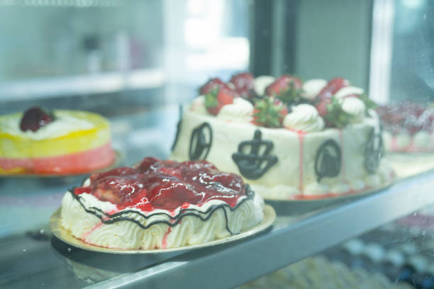 istock Close up of cherry and creme cake on display at bakery 1394606910