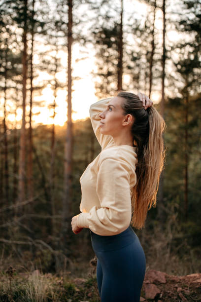 istock Athlete ties her hair in a ponytail before training 1394607478