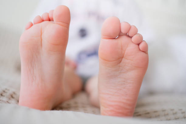 istock Close-up of childrens legs with feet forward. 1394608845