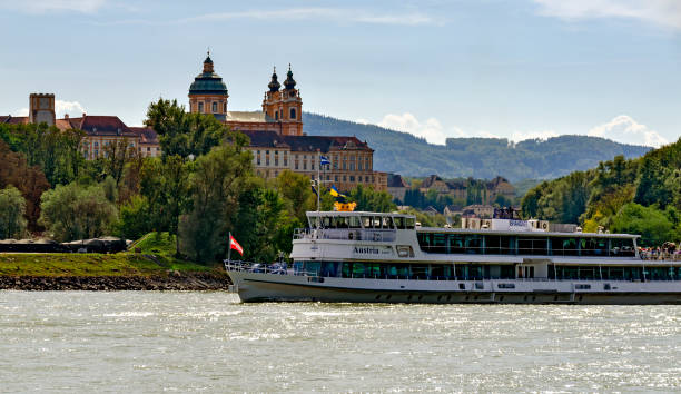 excursion ship on the river Danube before the abbey of Melk in the part of the Danube valley called Wachau, Austria