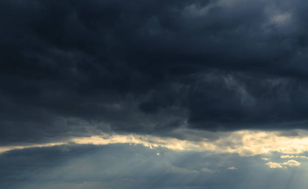 istock beautiful dramatic sky and sunlight, dark silhouette of clouds as background 1394612110