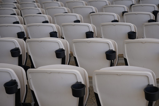 Angled symmetrical rows of seats in concert amphitheater.
