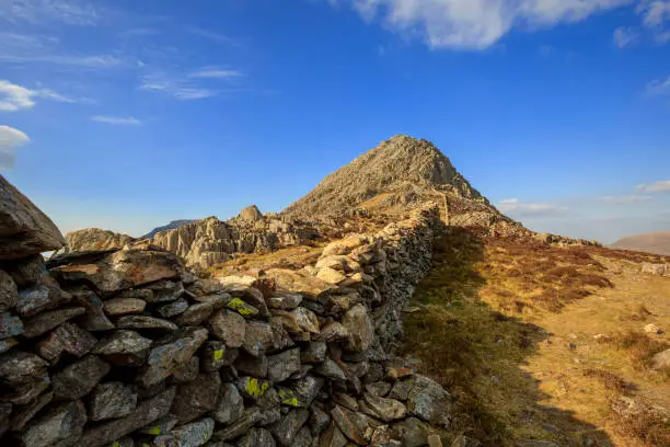 Drystone wall leading to the summit of Tryfan Mountain - Snowdonia, North Wales, UK