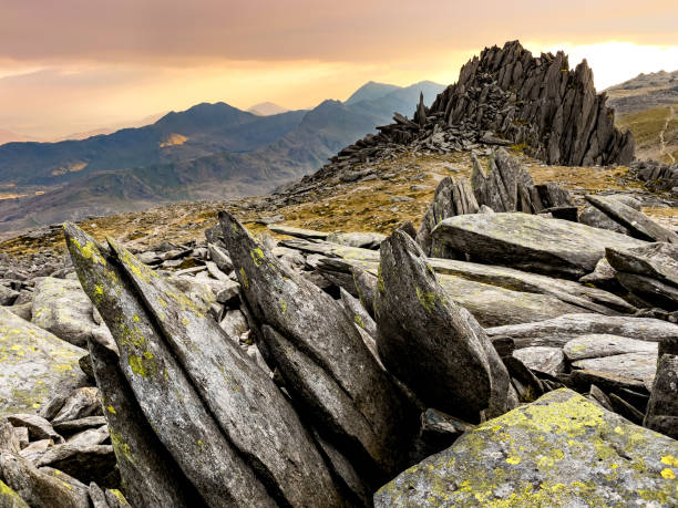 Jagged rocks near the summit of Glyder Fach with a view of Snowdon - Snowdonia, North Wales, UK stock photo