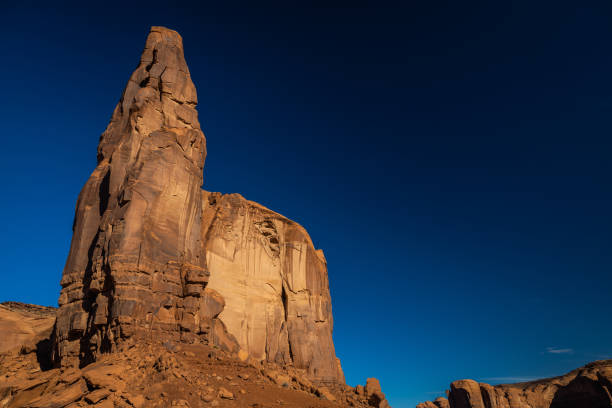 Classic southwest desert landscape under a blue sky and bright sun in Monument Valley in Arizona and Utah.