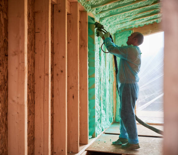 istock Worker spraying polyurethane foam for insulating wooden frame house. 1394617765