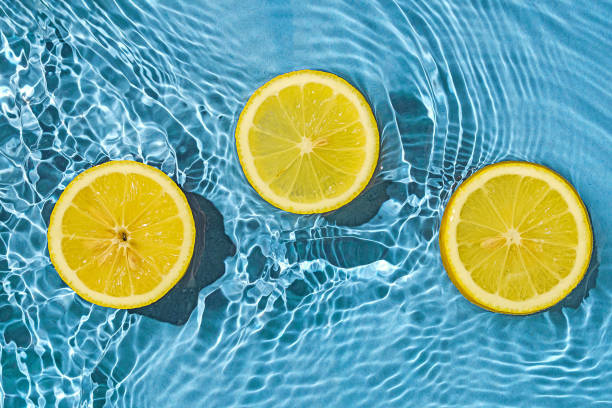istock Lemon citrus tropic exotic fruit in blue transparent fresh water with motion waves. 1394617964