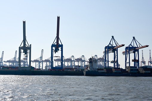 Container gantry cranes in Hamburg port backlit