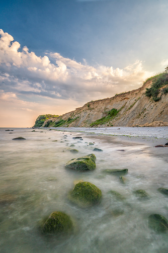 Huge cliffs on a beach at the Baltic sea during a colorful sunset.