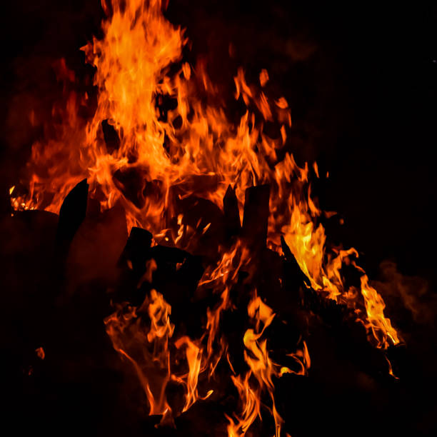 istock Fire flames on black background, Blaze fire flame texture background, Beautifully, the fire is burning, Fire flames with wood and cow dung bonfire 1394622619