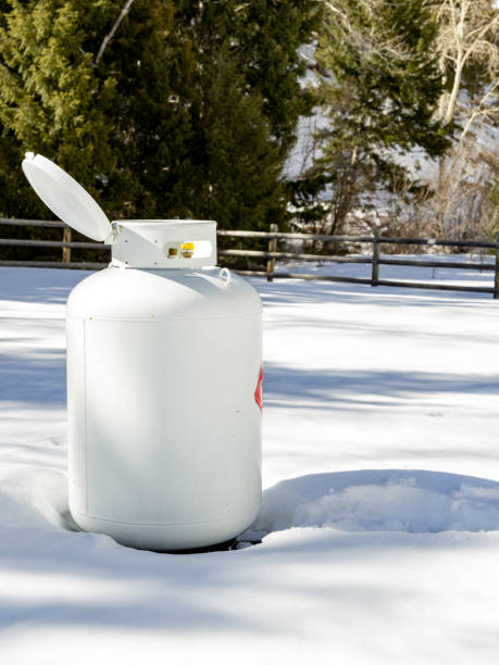 istock Extra Large tank of propane in a winter forest 1394625252
