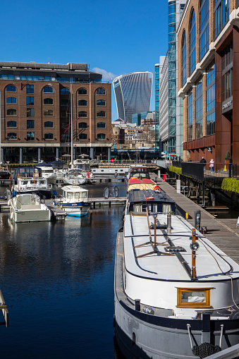 London, UK - March 18th 2022: View of the historic St. Katherines Dock in London, UK.  The Fenchurch Building, also known as the Walkie Talkie building is in the distance.