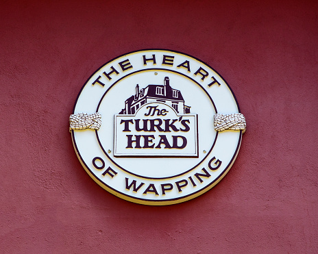London, UK - March 17th 2022: A plaque on the exterior of The Turks Head public house in Wapping, East London, UK.