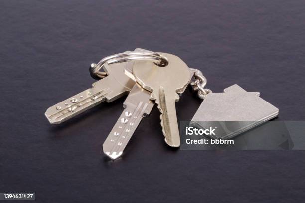Keys With House Shaped Keyring On Black Stock Photo - Download Image Now - House Key, Table, House