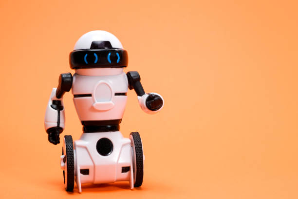 istock Robot on an orange background with a place for text for a toy store and children's technology centers. 1394631472