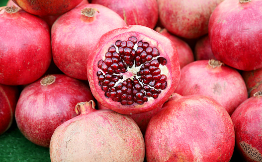 Close-up of a pomegranates (Punica granatum) fruit, packed in shipping crate ready for processing.