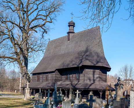 St. Leonard's Gothic wooden church in Lipnica Murowana in Lesser Poland. Built in the fifteenth-century. UNESCO World Heritage Site. Wooden soboty (undercut supported by pillars) and cemetery