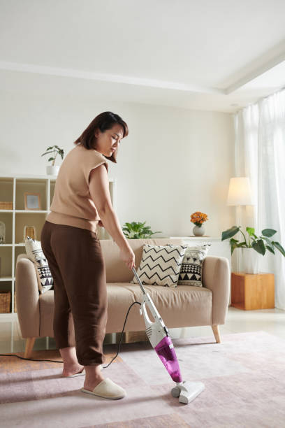 istock Woman Vacuum Cleaning Carpet 1394635834