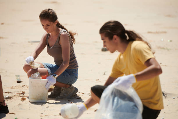 istock Woman Participating in Beach Cleanup 1394636365