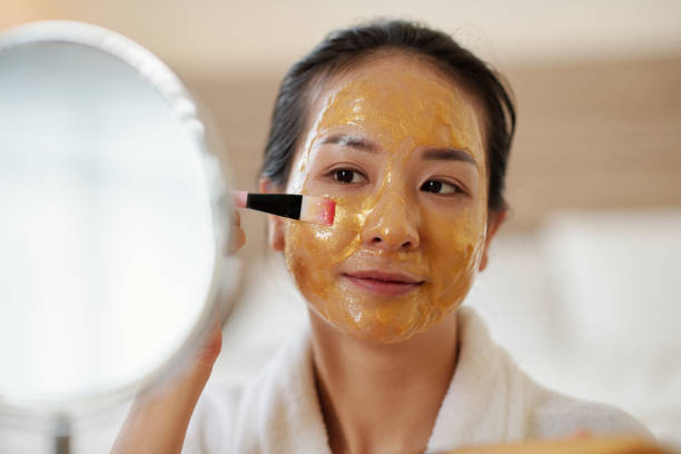 istock Woman Applying Gel Face Mask 1394637150