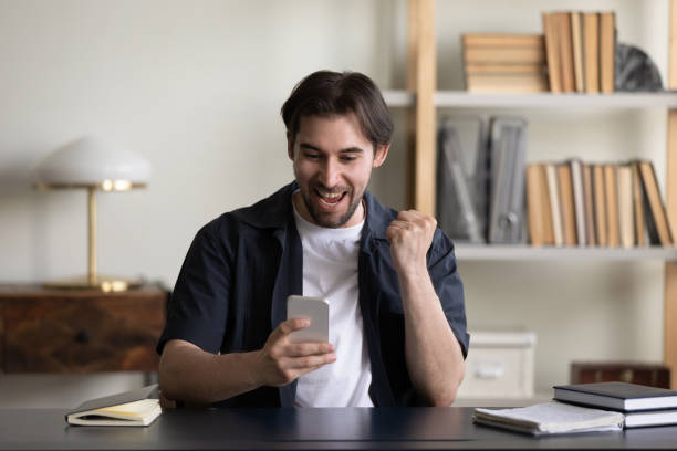 istock Cheerful excited smartphone user celebrating win, success, achieve 1394637410
