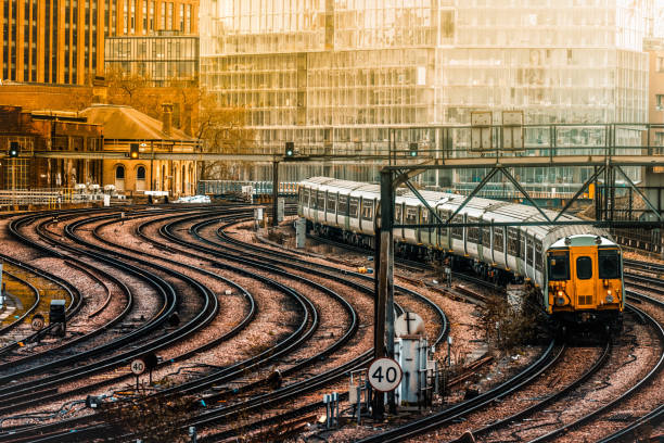 Battersea Power Station the iconic decommissioned coal-fired power station located on the south bank of the River Thames in London. The Art Deco landmark surrounded by cranes during redevelopment building work - seen from Victoria Railway Station approach and shunting yard with approaching trains