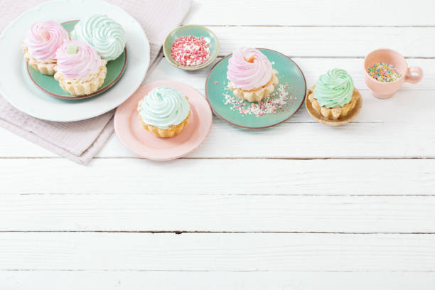 istock cupcakes on plates on white wooden background 1394638617