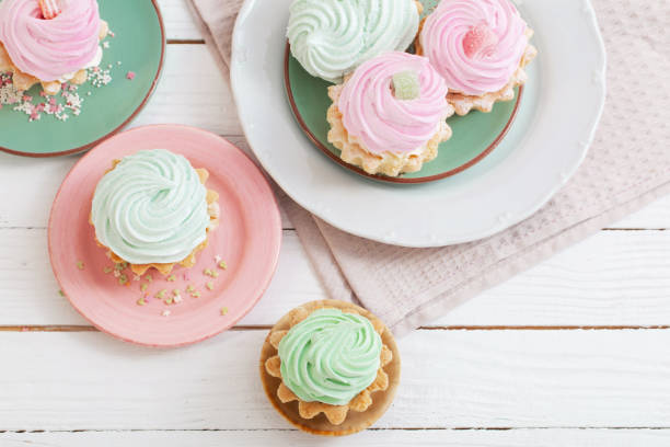 istock cupcakes on plates on white wooden background 1394638642