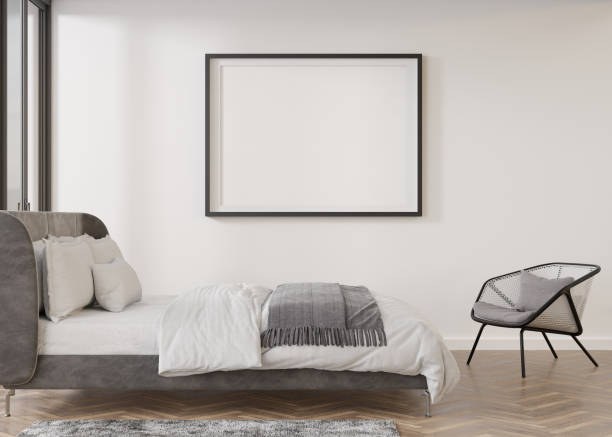 istock Empty picture frame on white wall in modern bedroom. Mock up interior in contemporary style. Free, copy space for your picture, poster. Bed, armchair. 3D rendering. 1394640313
