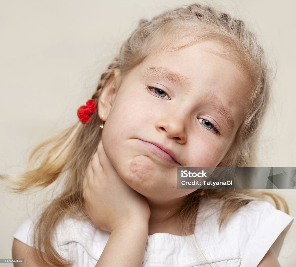 A portrait of a young girl with a sore throat Child has a sore throat. Angina Child Stock Photo