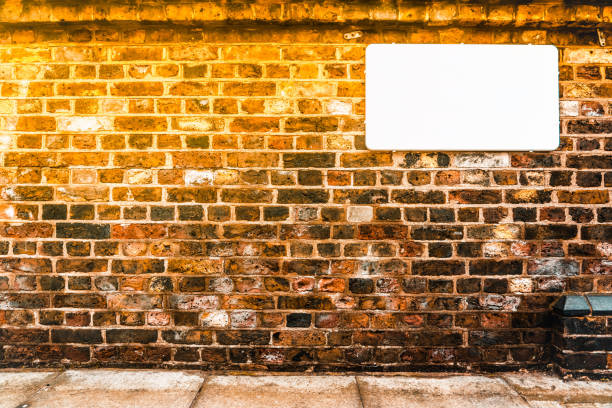 Blank white sign on a brick wall