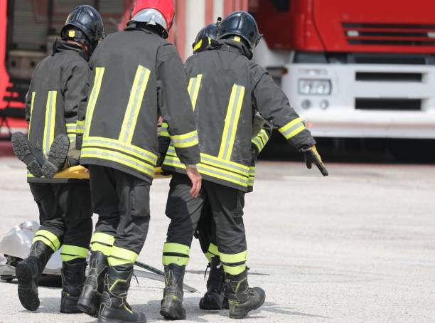 istock firefighters carrying the injured man with the stretcher 1394645302