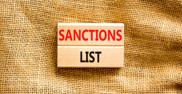 istock Sanctions list symbol. Wooden blocks with concept words Sanctions list on beautiful canvas background. Business political sanctions list concept. Copy space. 1394646010