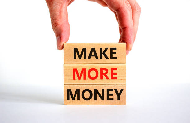 istock Make more money symbol. Concept words Make more money on blocks on beautiful white table white background. Businessman hand. Business and make more money concept. Copy space. 1394646023