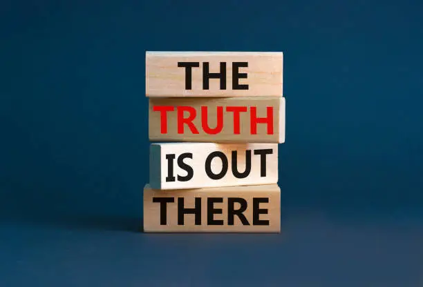 The truth is out there symbol. Concept words The truth is out there on wooden blocks. Beautiful grey table grey background. The truth is out there business concept. Copy space.